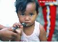 "Lumad Kid Enjoys the Chicken Feet"